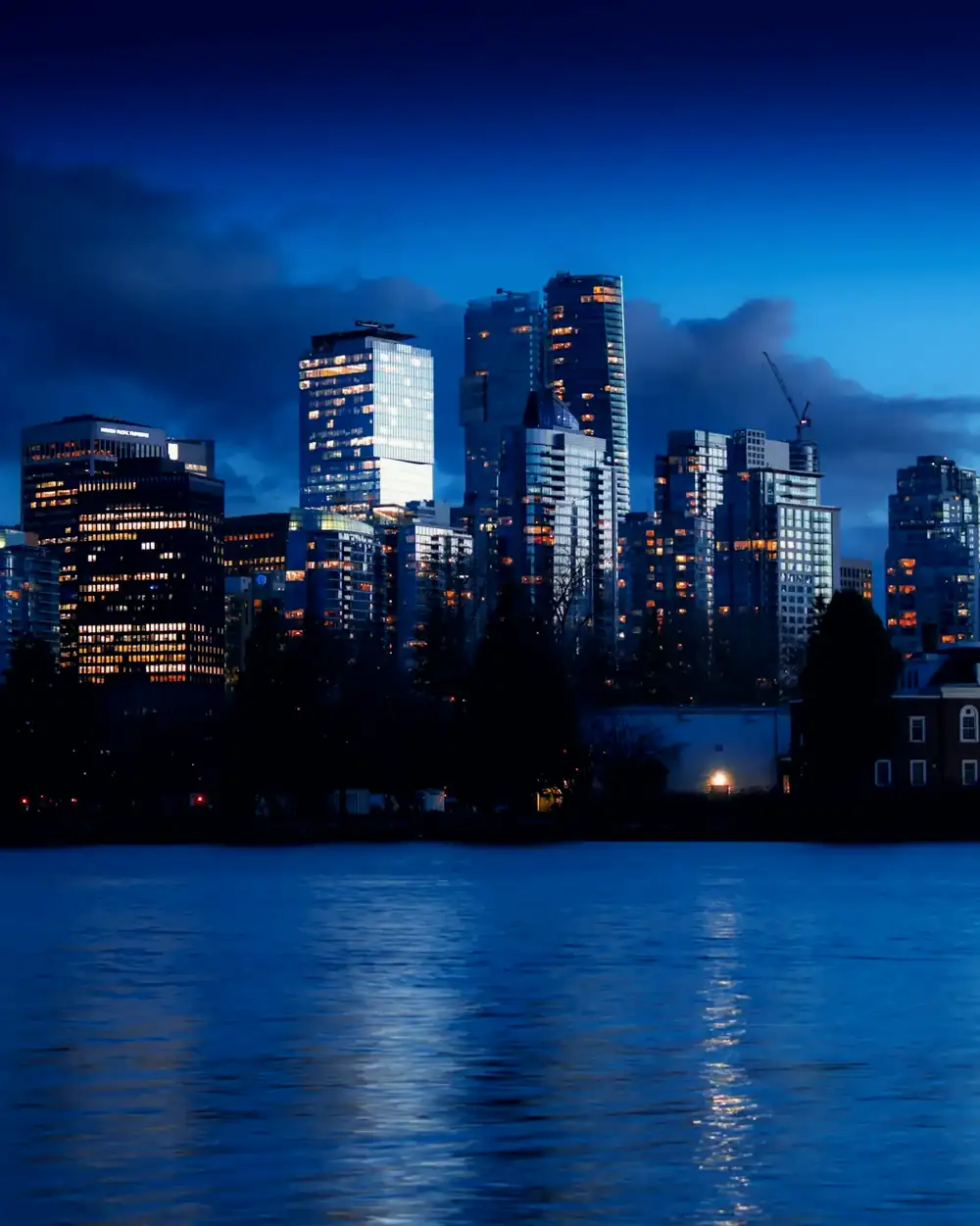 Downtown Vancouver towers at blue hour across the water from Stanley Park