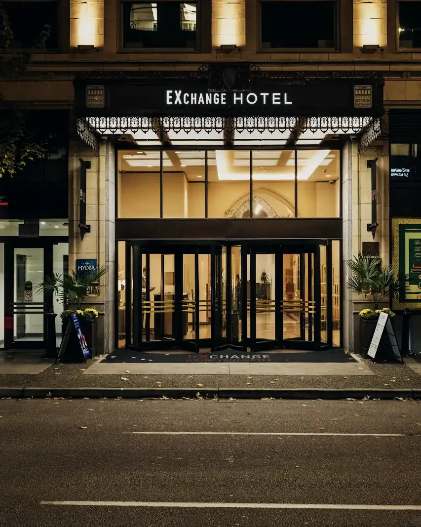 A downtown Vancouver hotel entrance lit at night