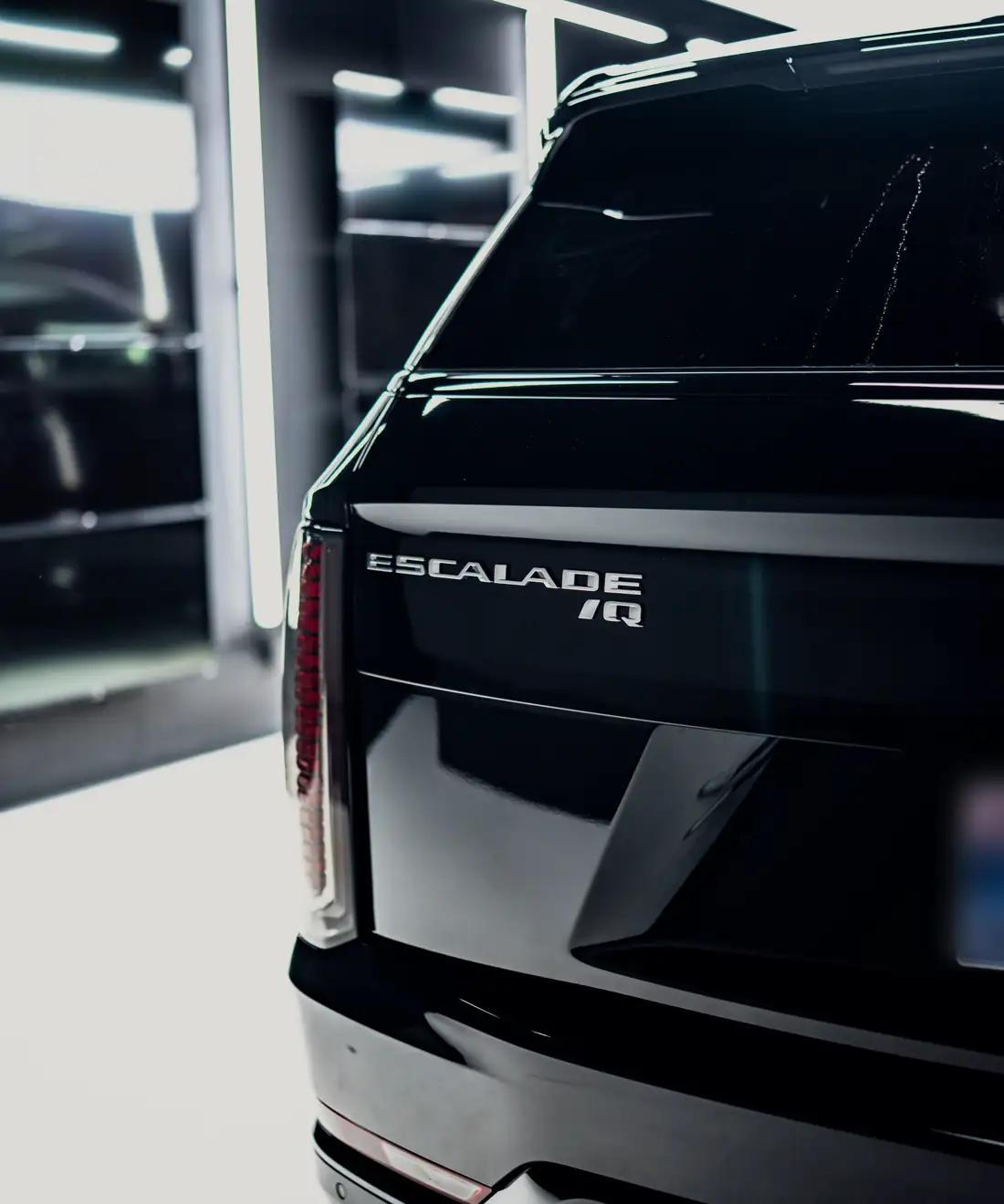 Escalade IQ badge on the tailgate of the black Hermes Travel Escalade IQ