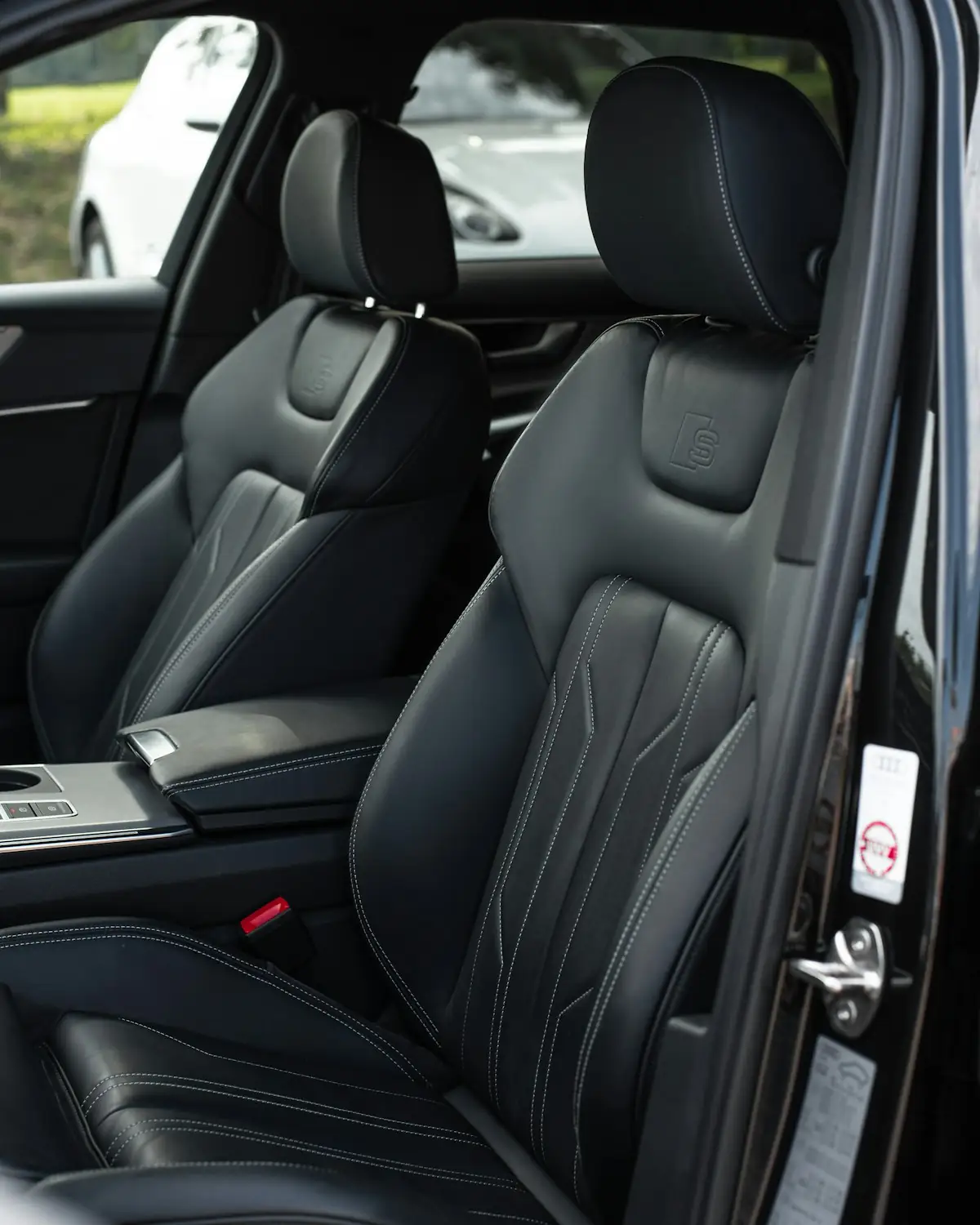 Black leather seats of a luxury car with the door open