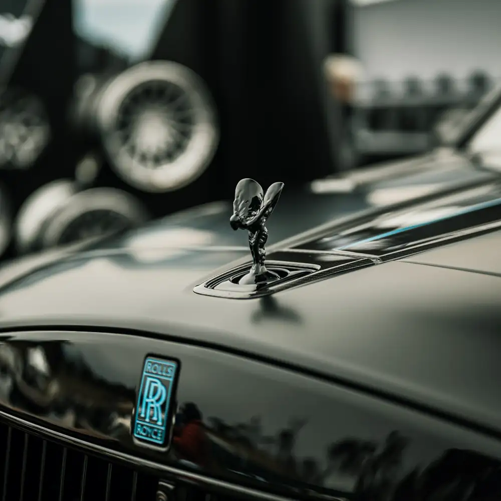 Spirit of Ecstasy mascot on the black bonnet of a Rolls-Royce