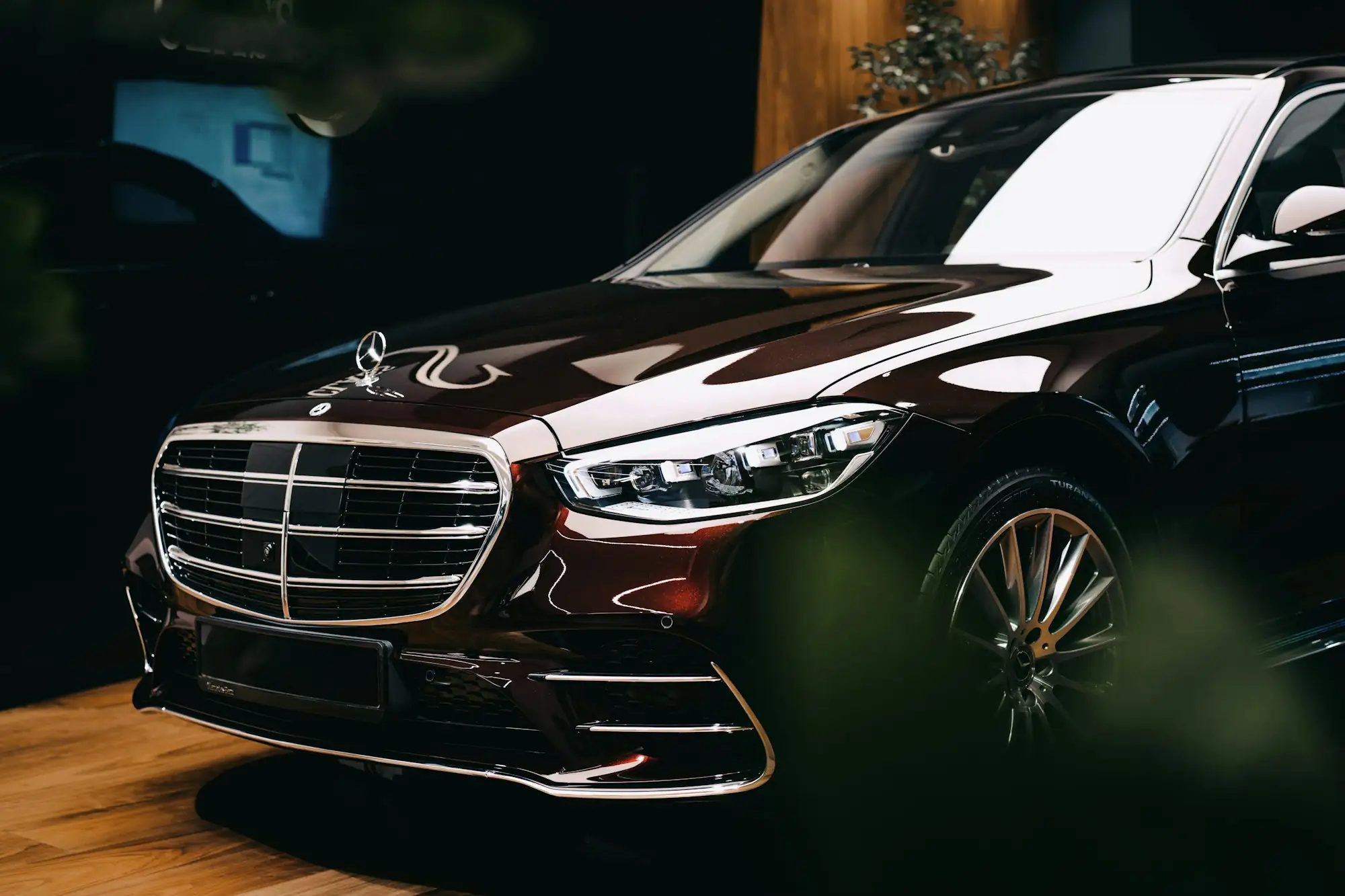 Black Mercedes-Benz S-Class, front three-quarter view in low light