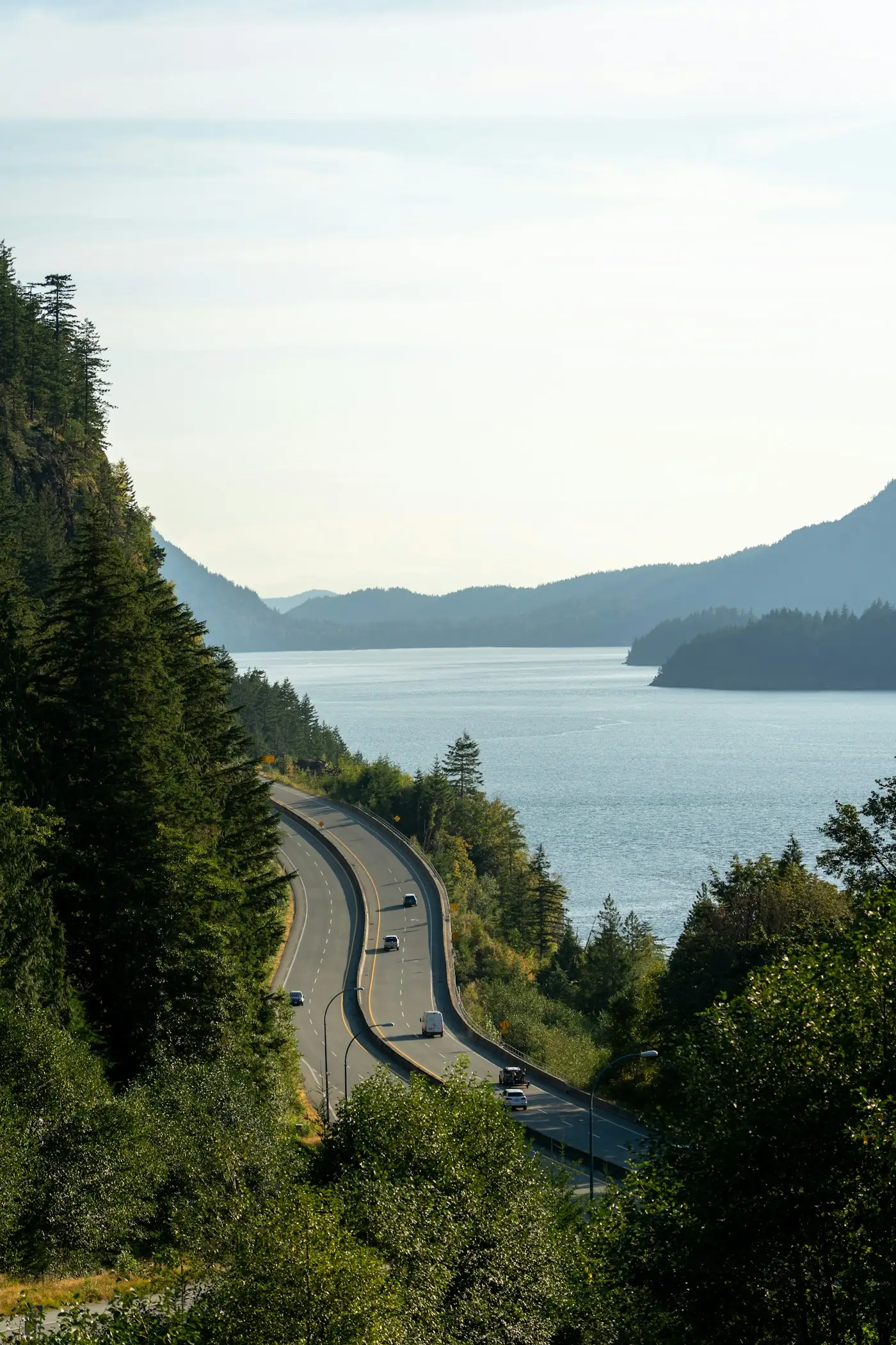 Sea-to-Sky Highway winding along Howe Sound beside forested mountains