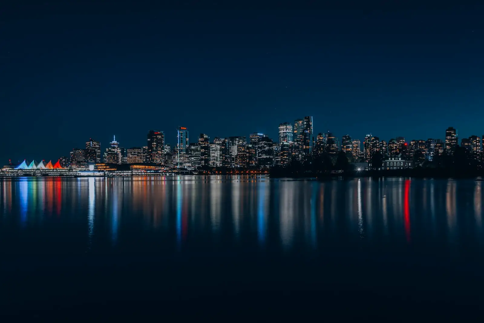 Downtown Vancouver towers lit up at night across the water