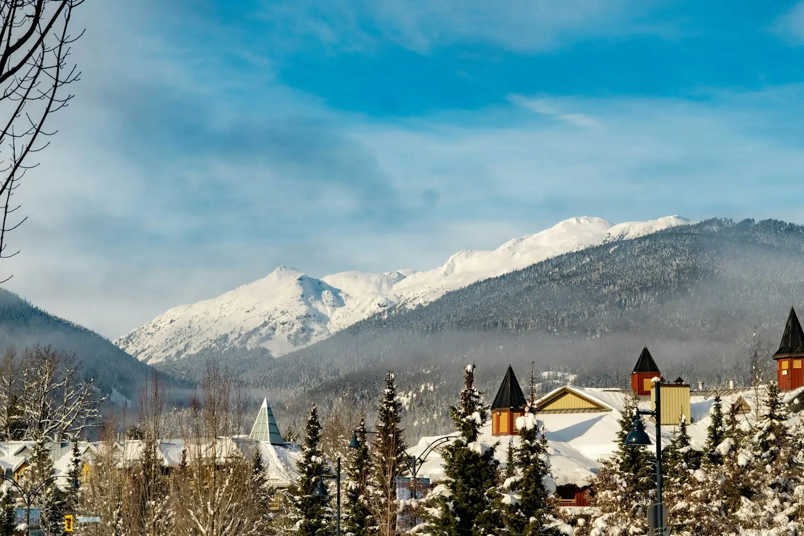 Whistler village in winter beneath snow-covered mountains